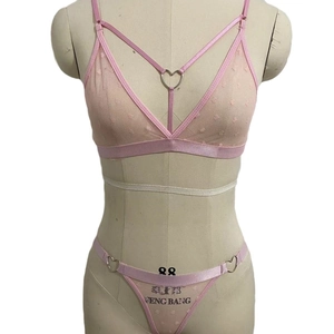 Pink sheer mesh lingerie set with heart rings and polka dots on a mannequin