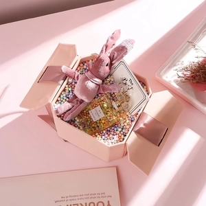 Pink hexagonal gift box set with velvet rabbit doll, perfume, and elegant greeting card
