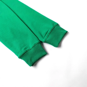 Close-up of green long sleeve sweatshirt featuring elastic ribbed knit cuffs and texture