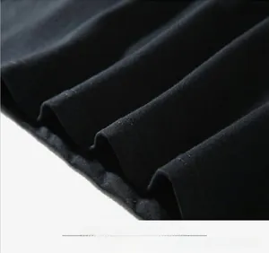 Close-up detail of double-needle stitching and high-quality black cotton knit fabric