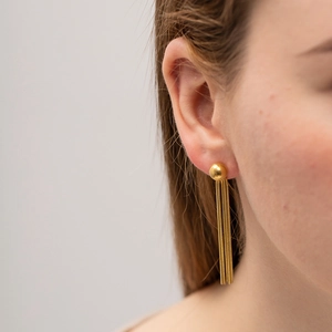 Fashion 18K gold titanium steel earrings with long snake chain tassels on a model