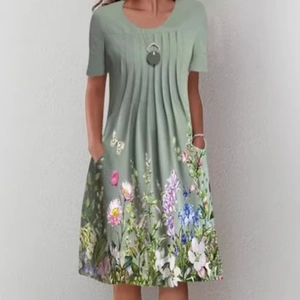 Short sleeve sage green midi dress featuring a pleated round neck and floral daisy print