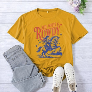 Flat lay of vintage American style t-shirt with horse rider print on mustard yellow fabric