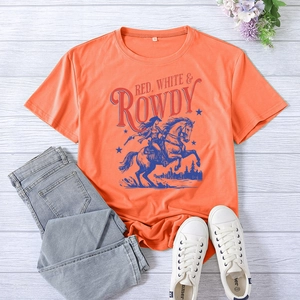 Flat lay of an orange cotton T-shirt with vintage cowboy graphic and denim jeans