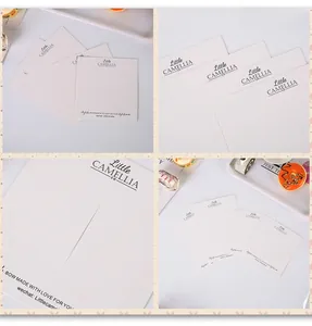 Detail of cream jewelry display card with vertical slits for bows and hair accessories