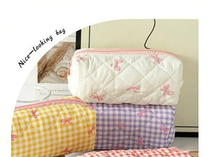 Quilted makeup bags with floral and checkered patterns showing soft texture and zipper