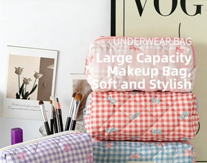Detailed close-up of colorful quilted cotton cosmetic bags with cute bow embroidery patterns