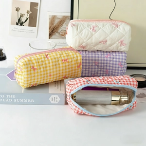 Quilted makeup bag with pink bow pattern showing large storage space for skincare