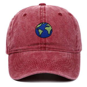 Close-up of earth embroidery on vintage washed burgundy cotton baseball cap with stitching