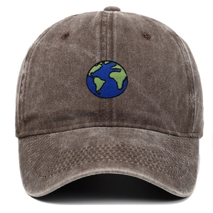 Close-up of embroidered earth logo on washed dark brown baseball cap with stitching detail