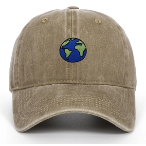 Detailed view of globe embroidery on khaki washed cotton baseball cap with curved brim