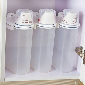 Three-piece transparent plastic food storage containers with measuring lids in cabinet