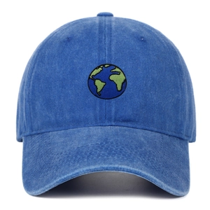 Close-up of earth embroidery on washed blue denim baseball cap with premium stitching