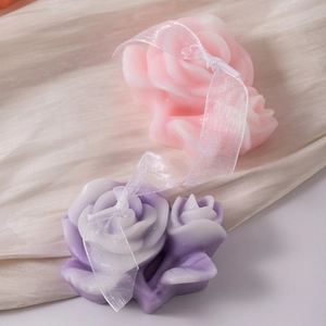 Rose shaped aromatherapy candle set with pink and purple petals and elegant silk ribbons