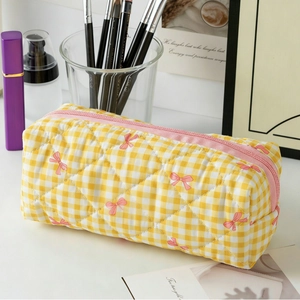 Quilted yellow checkered cosmetic bag with pink bow pattern and spacious interior