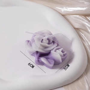Handcrafted rose scented candle set with elegant white ribbon bow in gradient purple color
