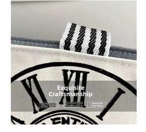Detail of canvas tote bag showing retro clock print and striped ribbon pull handle