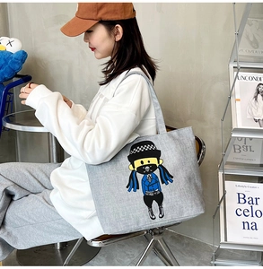Detailed view of casual canvas tote bag featuring street-style cartoon character print