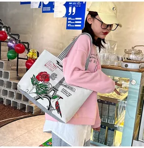 Detail of printed white canvas tote bag featuring Eiffel Tower and rose pattern on shoulder