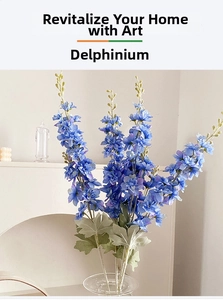 Detailed view of blue silk delphinium flowers in a glass vase for home interior decor