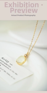 Macro shot of gold S925 silver necklace featuring a square yellow gemstone and tiny diamonds