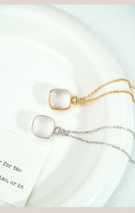 Detail of square pink crystal pendants with gold and silver frames on fine O-chains