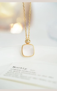 Detailed macro view of S925 silver square pink crystal pendant with gold plating