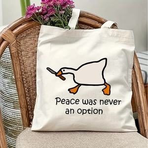 Detail of white canvas tote bag featuring a funny goose print and internal floral accents
