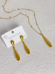 Detailed view of polished stainless steel water drop earring and necklace jewelry set