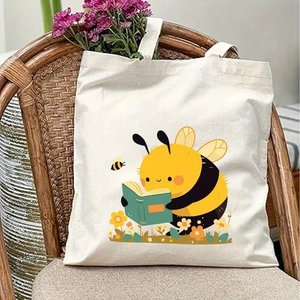 Detail of canvas tote bag featuring cartoon bee reading a book among small flowers