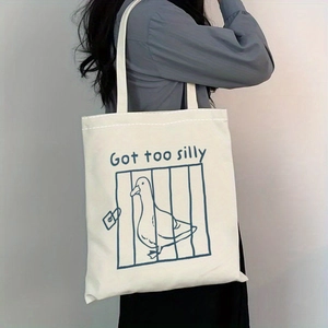 Detailed side view of off-white canvas tote bag with 'Got too silly' duck illustration
