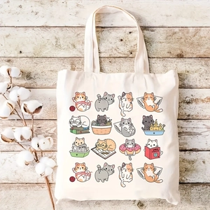 Detail of cream canvas tote bag featuring sixteen cute cartoon cat illustrations on wood