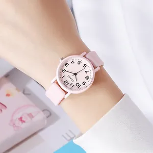 Close-up of a pink quartz watch with silicone strap worn on a wrist for students