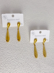 Detailed shot of gold teardrop earrings in polished and hammered stainless steel finish