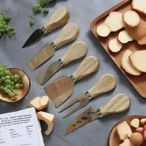 6-piece stainless steel cheese knife set with wooden handles on dark stone background
