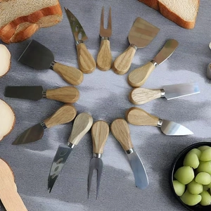 12-piece stainless steel cheese knife set with natural wood handles on a grey background