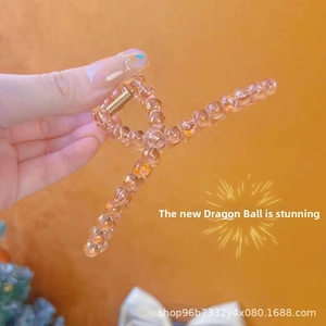 Detail of peach translucent beaded claw clip with durable gold metal spring
