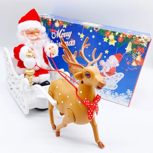 Detail of electric Santa Claus on white sleigh with reindeer toy in gift packaging