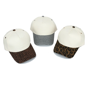 Detailed view of three baseball caps featuring leopard and houndstooth patterned brims