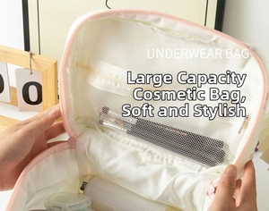 Detailed interior of quilted makeup bag showing spacious mesh zip pockets and pink zipper