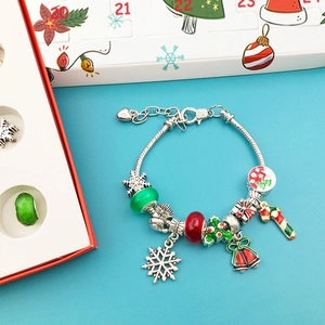 Detail of Christmas advent calendar bracelet with festive charms and silver snake chain