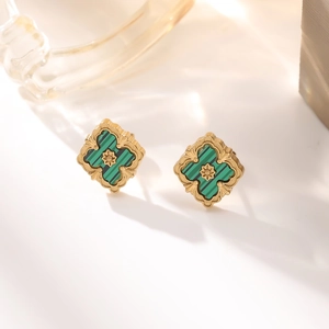 Macro shot of 18K gold plated clover earrings with malachite inlay and vintage detail