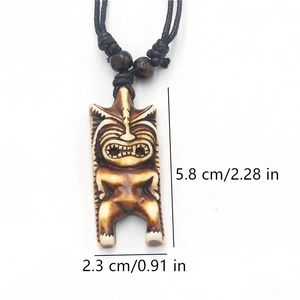 Detailed view of resin Tiki pendant with size markings 5.8cm height and 2.3cm width