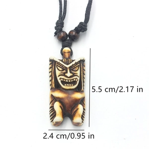 Detailed view of carved Tiki totem necklace showing dimensions 5.5cm by 2.4cm in resin
