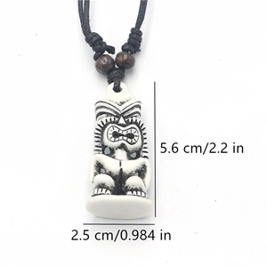 Detailed view of the Tiki totem pendant dimensions 5.6 cm by 2.5 cm with wood beads