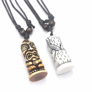 Polynesian Tiki totem pendants in dark brown and bone white resin with adjustable cords