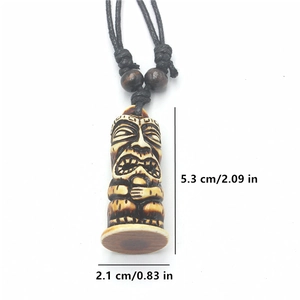 Detail view of bone-style Tiki pendant showing dimensions 5.3cm height and 2.1cm width