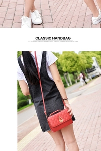 Macro view of red quilted leather handbag featuring a golden teardrop twist lock closure