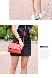 Detail of red quilted shoulder bag with gold teardrop lock shown on model outdoors