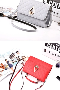 Detail of quilted faux leather handbags in grey and red with golden drop-shaped twist locks